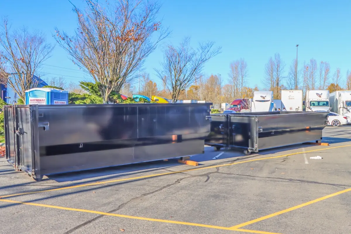 Professional dumpster rental service with roll-off container on residential driveway in Taft